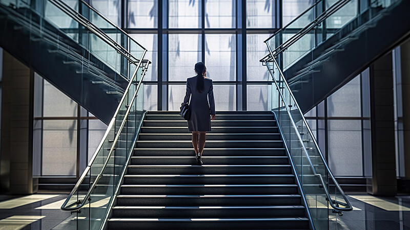 business_woman_walking_up_staircase